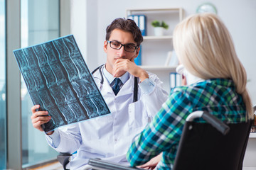 Disabled woman in wheel chair visiting man doctor