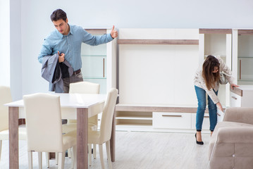 Married couple in the shop choosing furniture