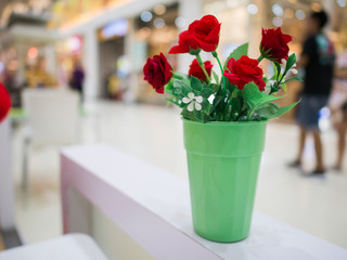 Red rose in green glass