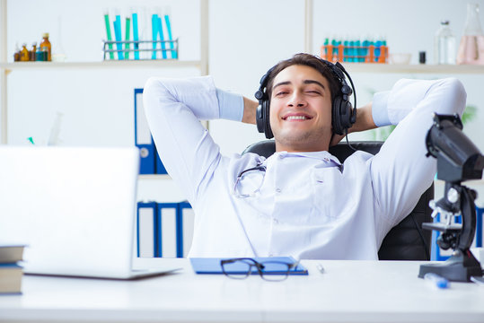 Happy Excited Doctor Listening To Music During Lunch Break In Hospital