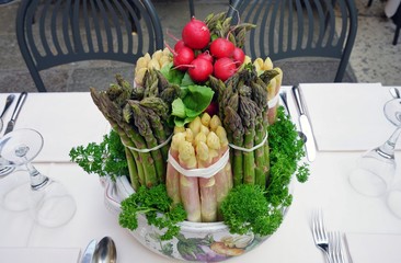 Table centerpiece decoration made with asparagus, radishes and vegetable