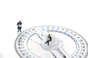 Miniature people: Businessman reading on Circle ruler, education or business concept.