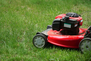 close up on lawn mower on green lawn