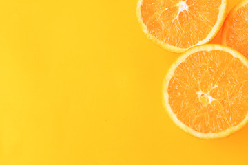 Close up of orange slices on yellow background