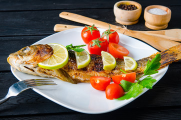 Fried fish served on the plate