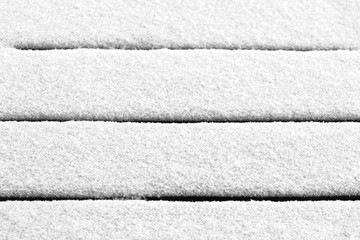 Fototapeta premium Fresh snow covers the wooden floor of the terrace.