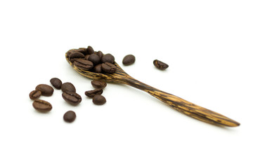 Coffee beans in a wooden spoon on a white background. Image use for coffee production, energy drink in the morning.