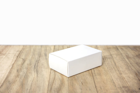 Empty white box mock up for product design on wood background
