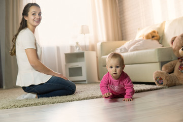 young mother plays with a baby.