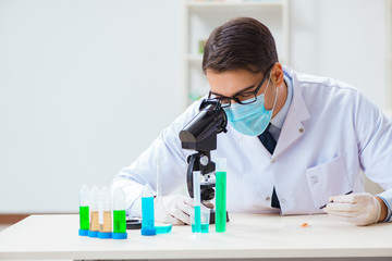 Man student working in chemical lab on experiment