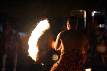 Polynesian Cook Islander man fire dance in cultural performance in Rarotonga, Cook Islands