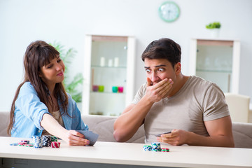 Young family playing cards at home