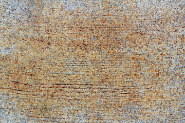 Granite slab with scratches and brown stains. Natural stone texture