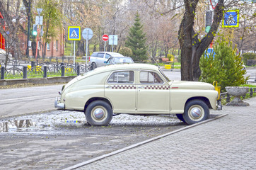 Retro car produced in 1955. Produced in the Soviet Union, after the second world war. This sample is still "on the go" and is used as a taxi in one of the hotels in the city. Russia. Siberia.