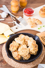 Homemade nuggets from chicken in a iron frying pan