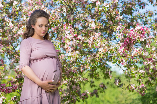Pregnant woman in a spring park