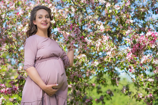 Pregnant woman in a spring park