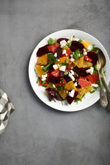 Beetroots salad with oranges on loft background