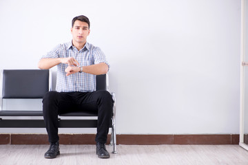 Man nervously impatiently waiting in the lobby