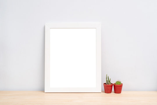 Blank Photo frame on wooden table in the room