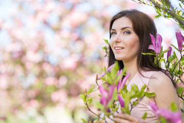 Naklejka premium Young woman in the garden blooming
