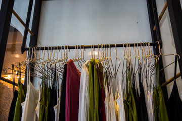 Fashionable clothes is hanging in the store