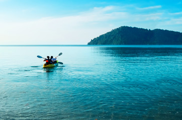 Kayak at dawn in the calm sea. Tourists go kayaking off the coast of Koh Chang, Thailand