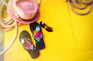 Set of Woman's Things Accessories to Beach Season Straw Beach Woman's Hat Top View Yellow Background Flat Single.