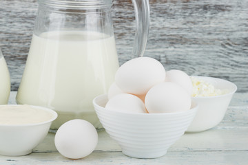 Different dairy products on the wooden background