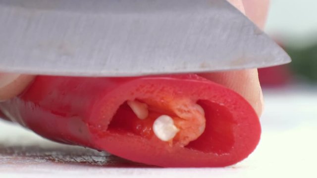 Sliced red chili pepper close up. White background