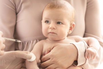 Doctor vaccinating baby in clinic