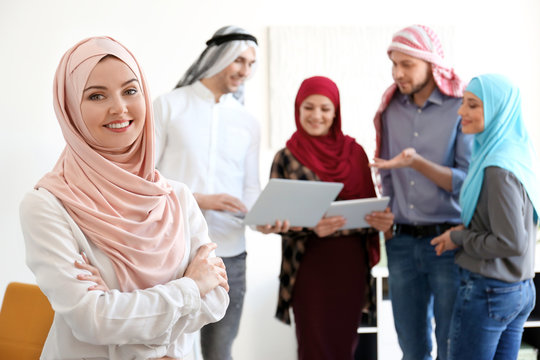 Muslim businesswoman and her colleagues at workplace