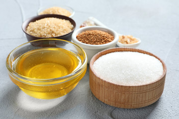 Various kinds of sugar and honey on light background