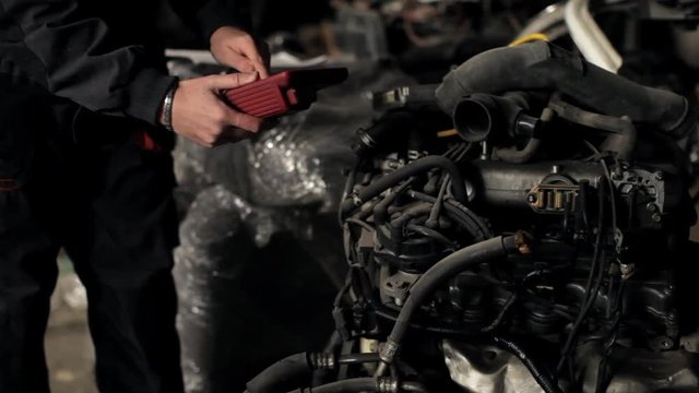 man with an auto-scanner diagnoses the engine