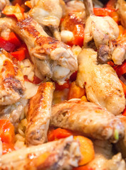 A roasted chicken pieces with vegetables .