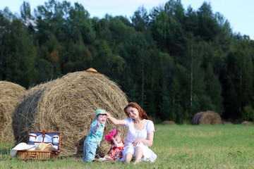 Naklejka na ściany i meble mother with twins in field