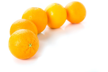 Fresh ripe five oranges on a white background.