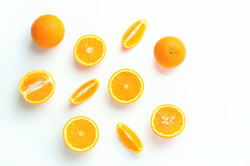 Top view group of slices and whole of orange fruits on white background.