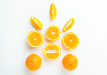 Top view of slices and whole of orange fruits on light background. Composition of oranges.