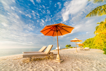 Beach loungers white sandy beach in Maldives island. Tropical vacation background