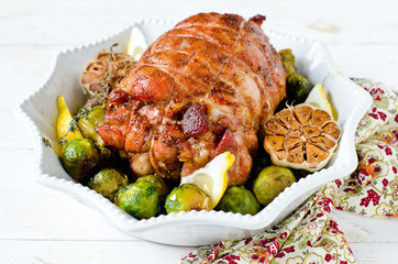 Baked turkey roll with Brussels sprouts, garlic, thyme and lemon