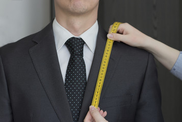 Taking measurements from a business man, close-up