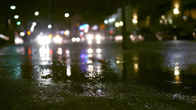 Rainy evening with traffic in urban city area - suspense style filler shot