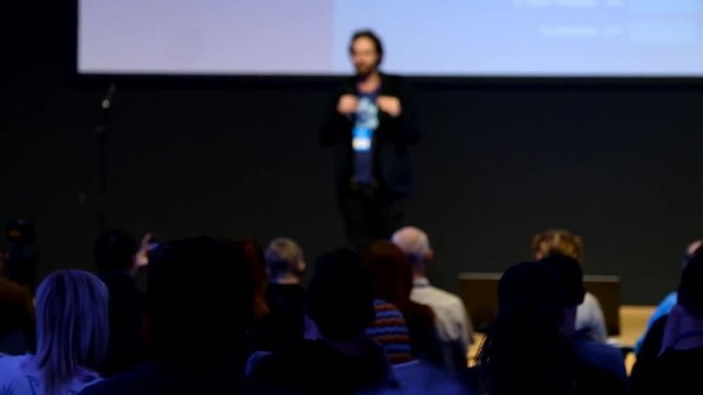 Audience listens to the lecturer at the conference hall