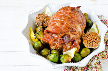 Baked turkey roll with Brussels sprouts, garlic, thyme and lemon