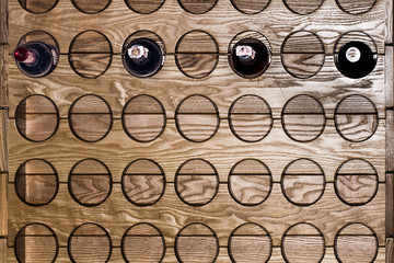 A wall mounted round wine rack in cellar
