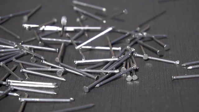 Falling metal nails slow motion 