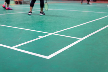 badminton court with player in game