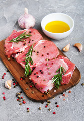 Fresh raw pork chops with spices and herbs