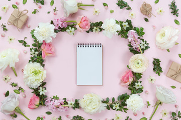 Top view and flat lay with notebook and frame of flowers on white background